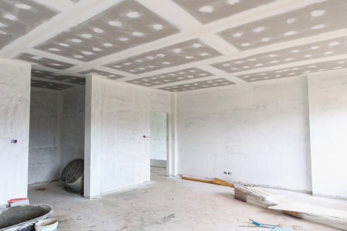 Empty room interior with gypsum board ceiling at construction si